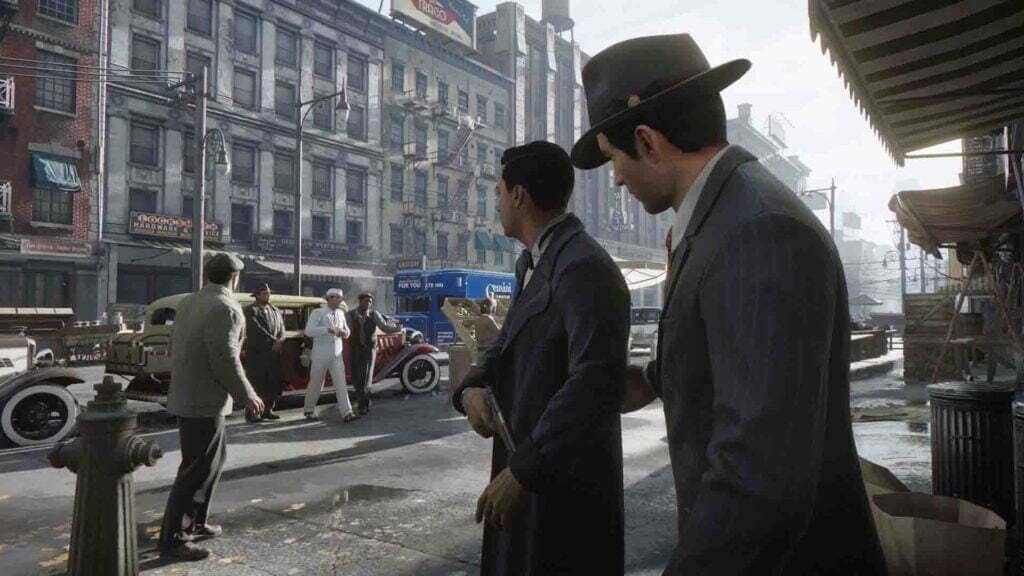 Cảnh đấu súng và hệ thống chiến đấu đầy kịch tính của Mafia Definitive Edition. Nhân vật chính Tommy Angelo cầm súng trường chiến đấu bên cạnh một người đồng đội trong Mafia Definitive Edition.