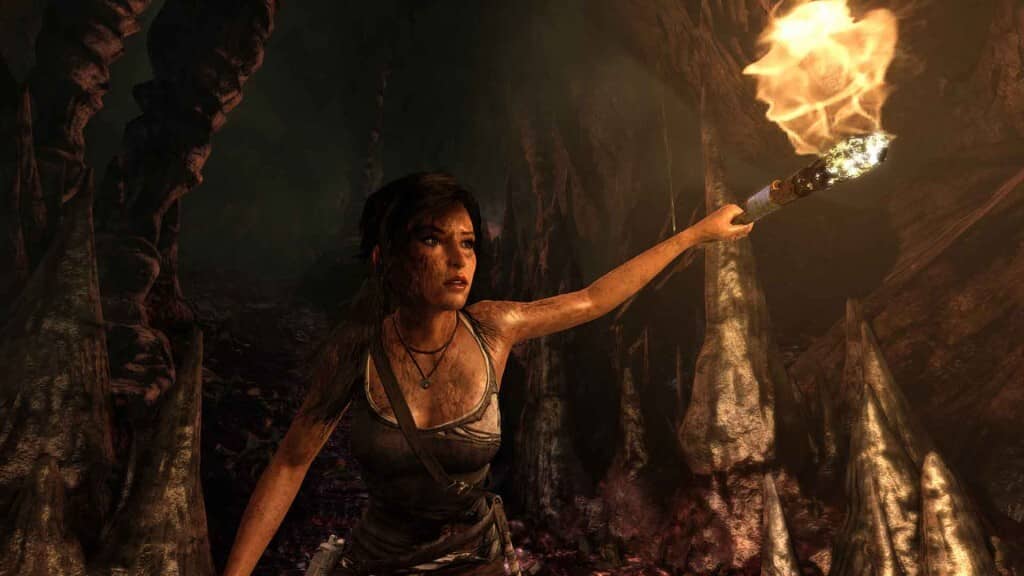 Gameplay Tomb Raider Definitive Edition: Thám hiểm những hang động bí ẩn. Lara Croft khám phá hang động ẩm ướt, ánh đuốc soi đường trong Tomb Raider Definitive Edition.