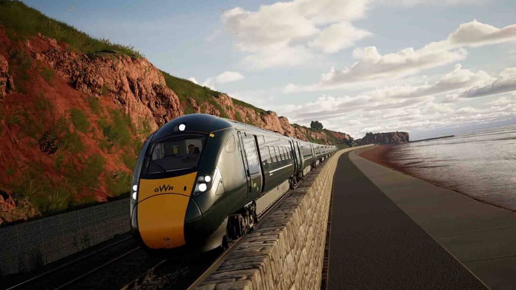 Train Sim World 6, tàu GWR chạy dọc bờ biển đầy nắng với vách đá đỏ.
