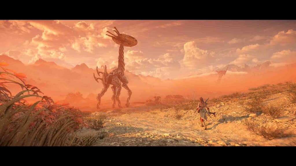 Horizon Forbidden West Aloy đi dưới chân Tallneck trong khung cảnh sa mạc màu cam hoàng hôn