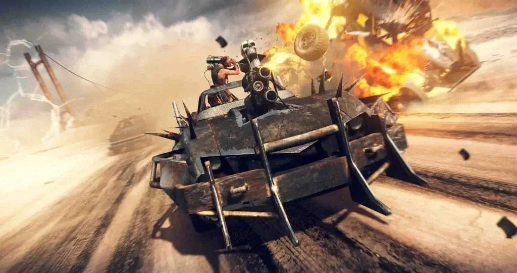 Chiếc xe độ Magnum Opus trong game Mad Max lao đi giữa sa mạc đầy khói lửa và vụ nổ hoành tráng.